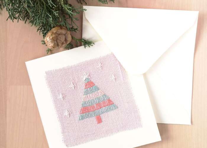 Postcard with Christmas tree embroidery on pink linen